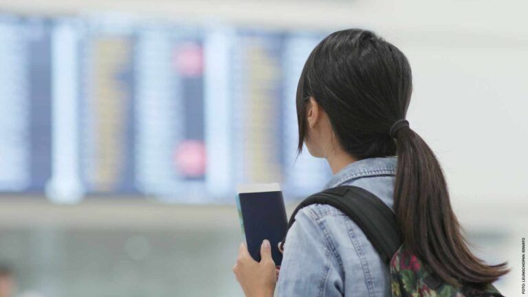 Travel woman holding passport in the airport