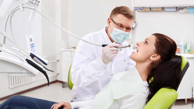 The dentist treats teeth of patient