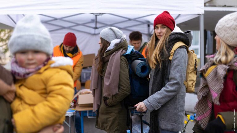 Ukrainian immigrants crossing border and getting donations from volunteers, Ukrainian war concept.