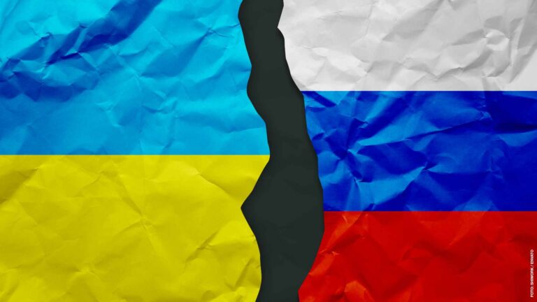 Ukraine and Russia flags painted on paper wall background, political partnership conflicts concept
