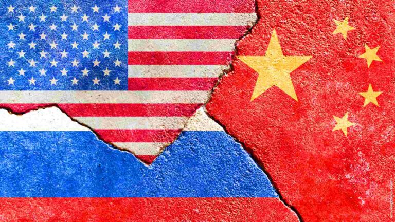 American, Chinese, and Russian flag on a cracked wall- politics, conflict, war concept