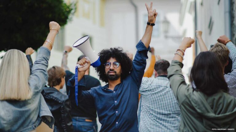 Group of people activists protesting on streets, strike and demonstration concept.