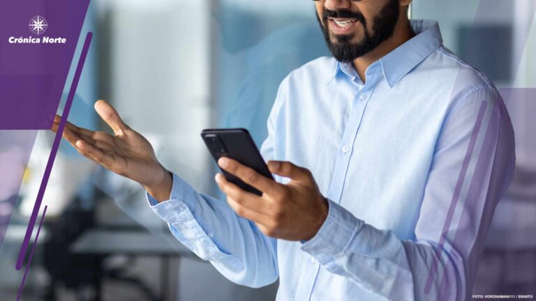 Upset and sad hispanic man inside office standing near window, businessman received message notification with bad news, man holding phone, reading information on smartphone app