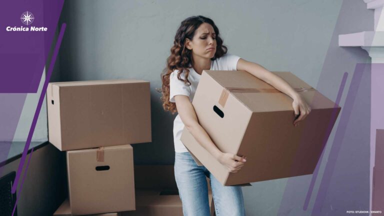 Tired female tenant carrying box with things leaving rented apartment. Eviction, hard relocation day