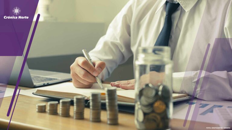 Man's is calculating financial graphs with coins to save money,