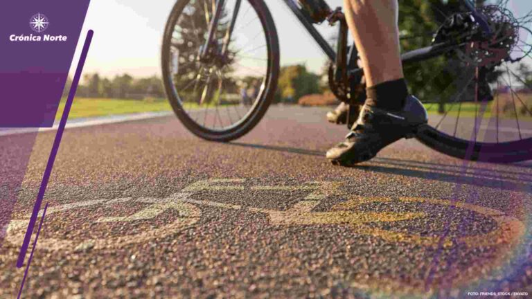 Close up of a bicycle sign drawn on asphalt. Professional male cyclist standing with his road bike on a cycle path