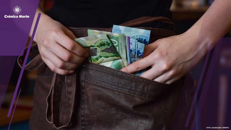 Server using pockets of her apron to keep cash money tips
