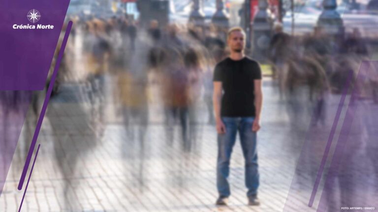 The man stands on the crowded street.