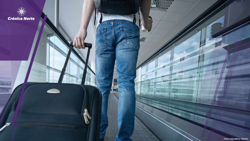 Man walking with suitcase at airport terminal