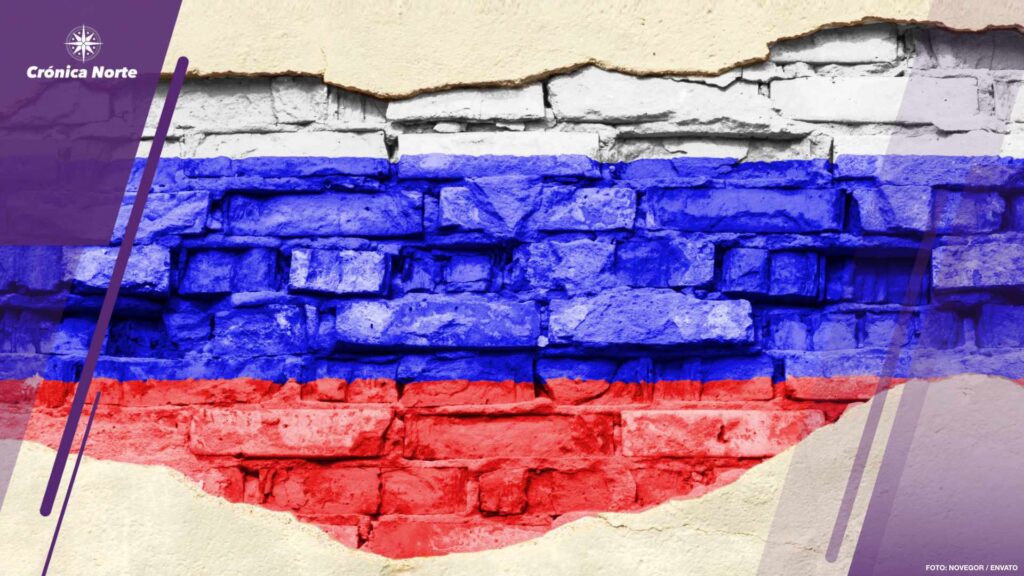 National flag of Russia on a brick background. Brick wall with partially destroyed plaster, background or texture.