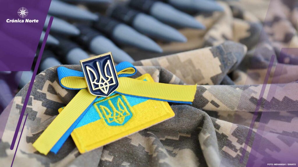 Ukrainian symbol and a machine gun belt on the camouflage uniform of a Ukrainian soldier. The Concept of war in Ukraine, patriotism and protecting your country from occupiers