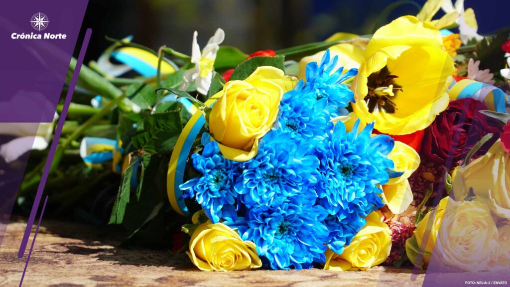 Funerary urn with ashes of dead and flowers at funeral. Burial urn decorated with flowers and people mourning in background at memorial service, sad and grieving last farewell to deceased person.