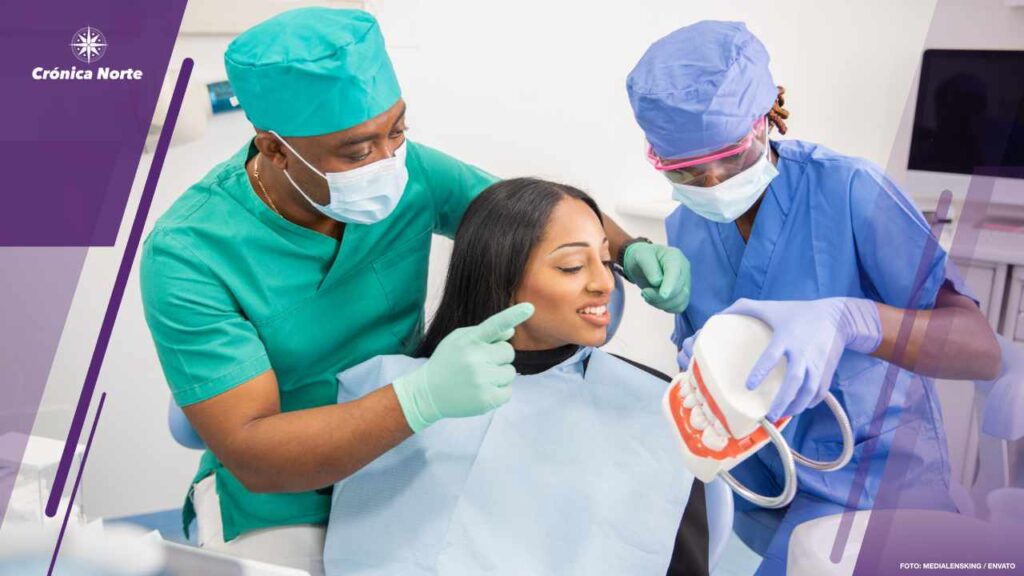 A dentist gives a consultation to a patient and with his assista