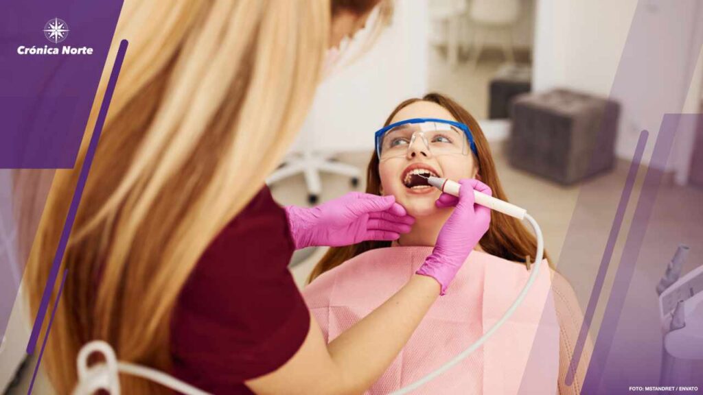 Little girl in protective glasses visiting dentist in clinic. Conception of stomatology