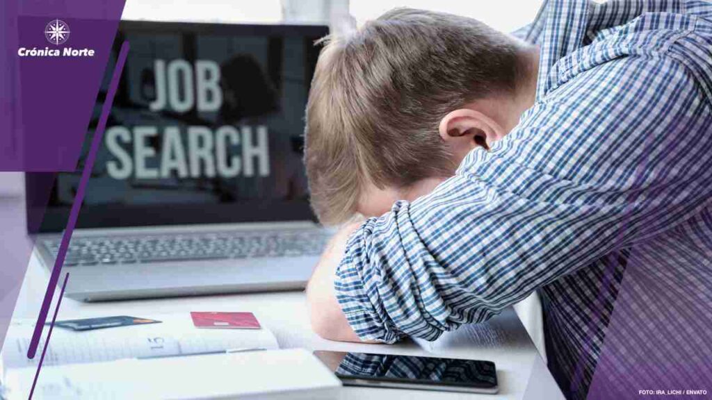 Man lies face down on table next to laptop. Unemployment, crisis, stress, job loss. Looking for remote work at home.Mobile phone,organizer,empty credit cards.Hiring employees,freelancers for telework