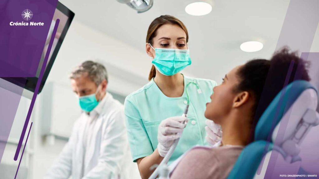 Young nurse preparing patient for dental procedure at dentist's office.