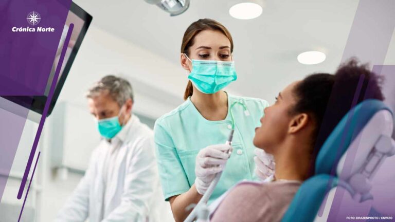 Young nurse preparing patient for dental procedure at dentist's office.