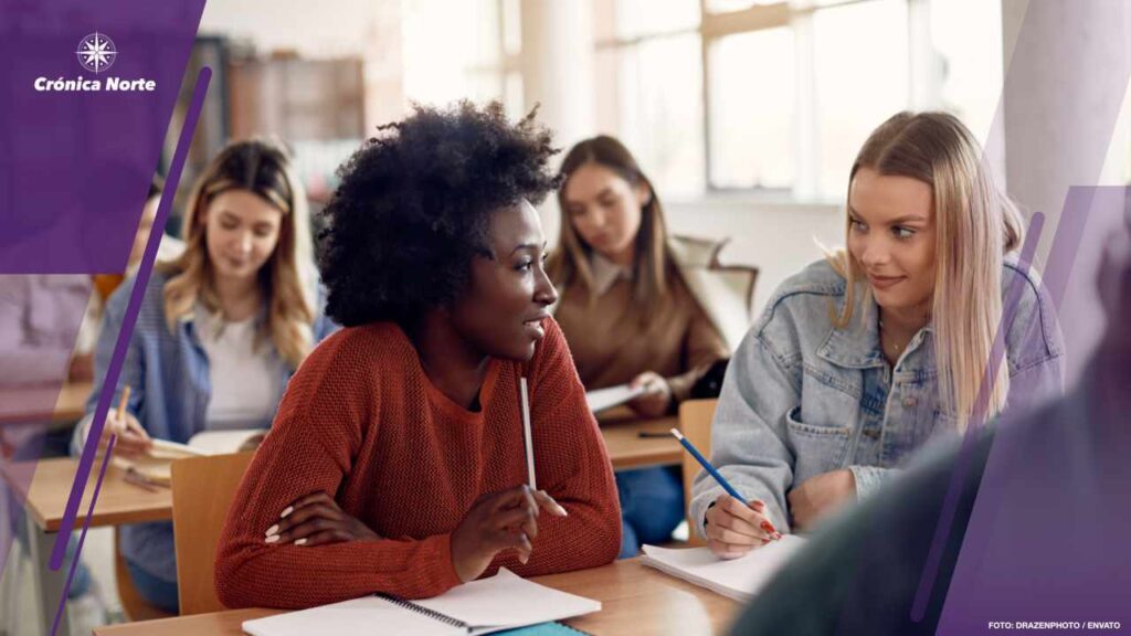 Female college students talking during a class in the classroom.