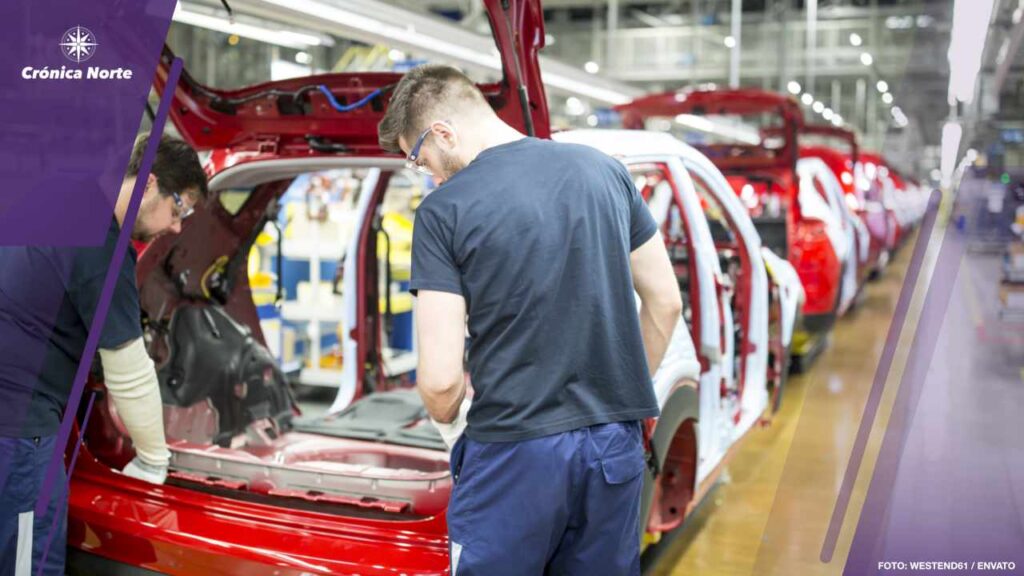 Two colleagues working in modern car factory